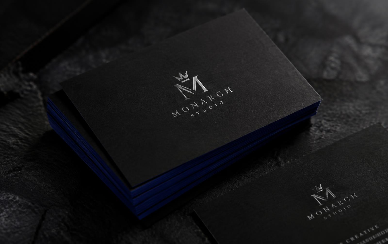 Stack of black Monarch Studio cards with blue painted edges
